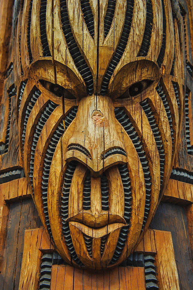 Traditional wood carved mask in the Te Puia Maori Cultural Center, Rotorura, North Island, New Zealand, Pacific