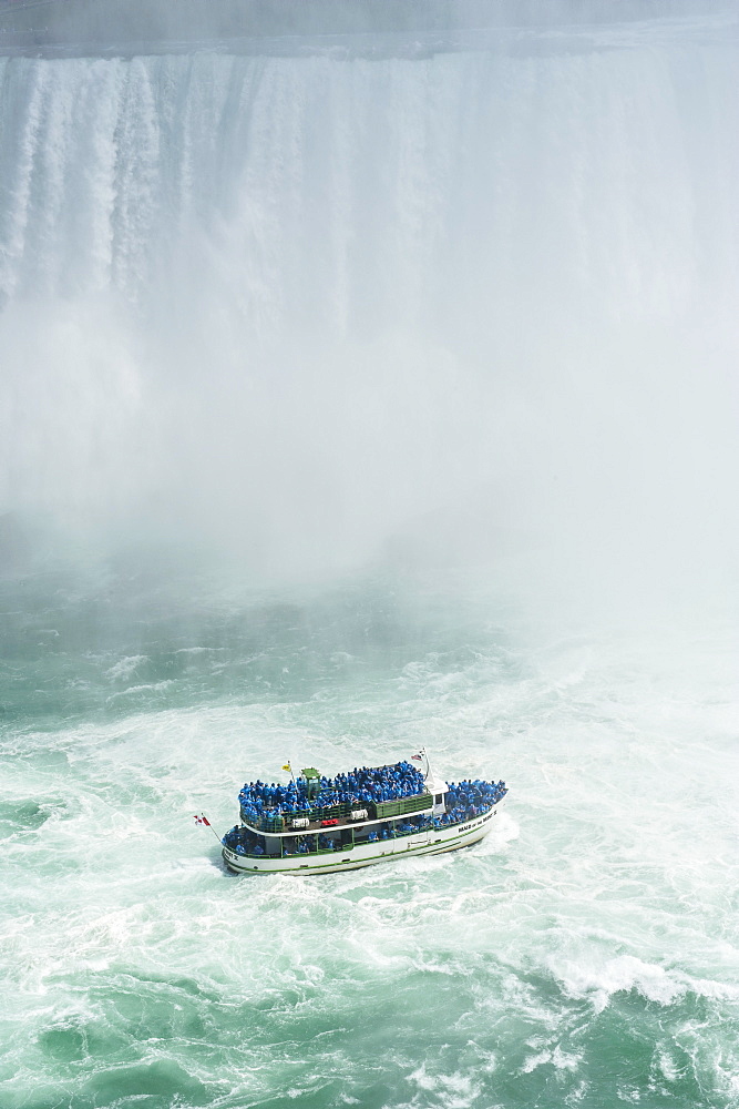 Tourist boat in the mist of the Horseshoe Falls (Canadian Falls), Niagara Falls, Ontario, Canada, North America