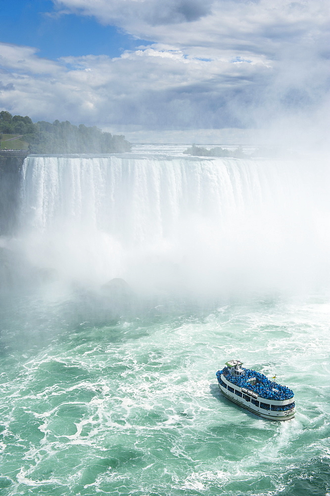 Tourist boat in the mist of the Horseshoe Falls, or Canadian Falls, Niagara Falls, Ontario, Canada