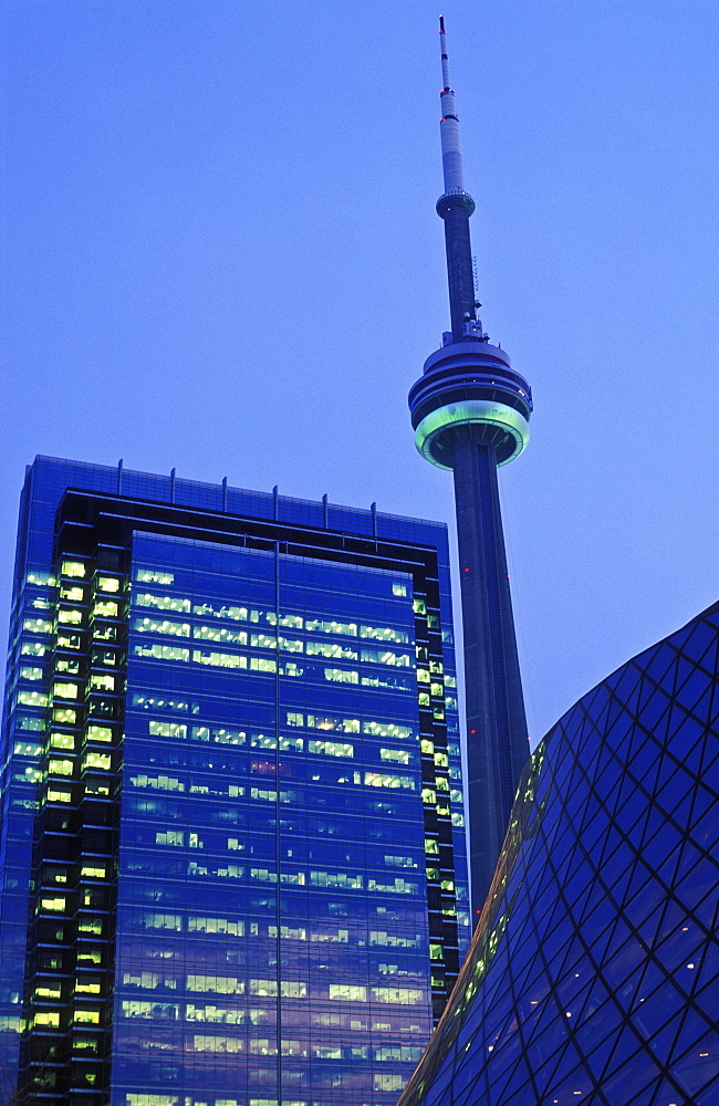 CN Tower and office building illuminated at dusk, Toronto, Ontario, Canada, North America