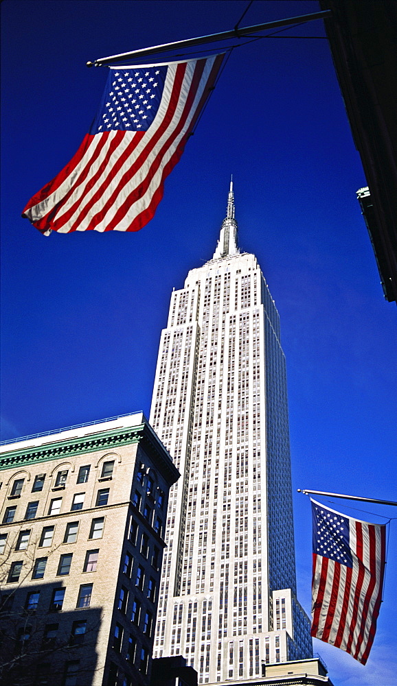 Empire State Building with US flags, New York City, New York, United States of America, North America