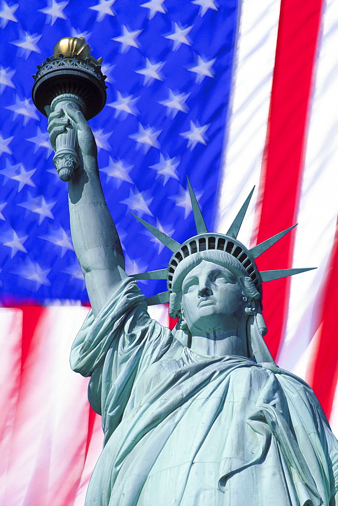 Statue of Liberty against American flag, New York City, New York, United States of America, North America