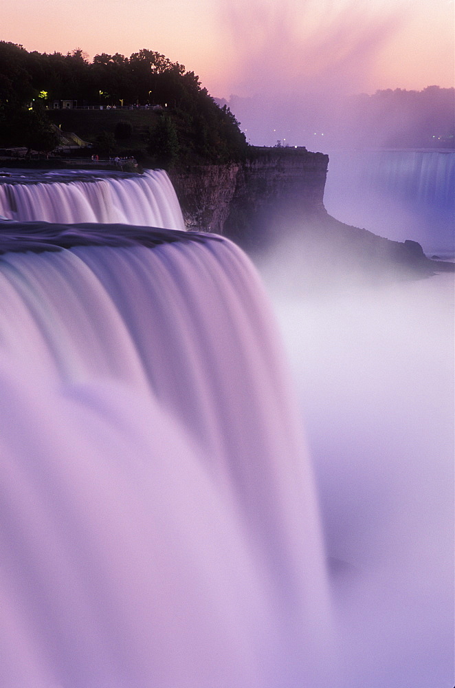 American Falls at dusk illuminated with colored lights, Niagara Falls, New York State, United States of America, North America