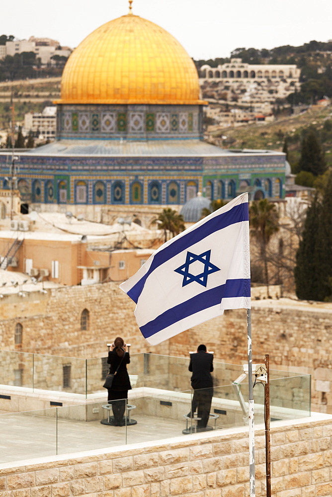 Couple looking over to the Dome of the Rock and the Wailing Wall at dusk, Jerusalem, Israel, Middle East