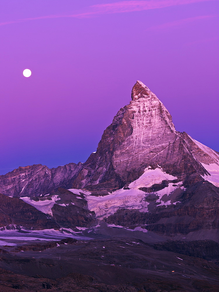 Moon setting over the Matterhorn at dawn, Gornergrat, Zermatt, Valais, Switzerland, Europe