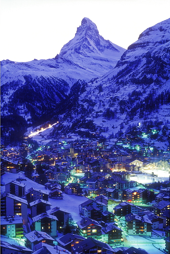 View of town in winter at dusk with the Matterhorn, Zermatt, Valais, Switzerland, Europe