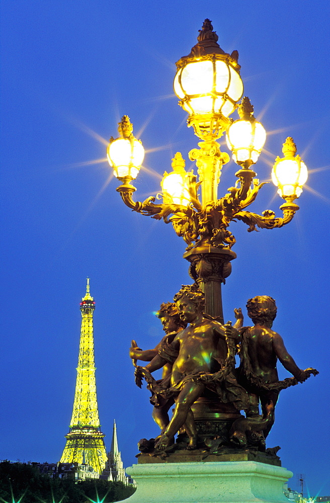 Lamp post on the Pont Alexandre III and the Eiffel Tower in the distance, Paris, France, Europe