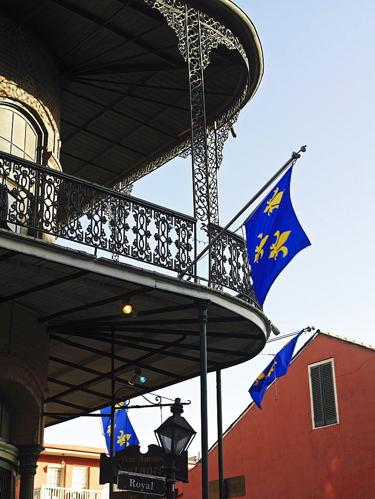 French Quarter building with wrought iron balconies and fleurs de lys flags, New Orleans, Louisiana, United States of America, North America