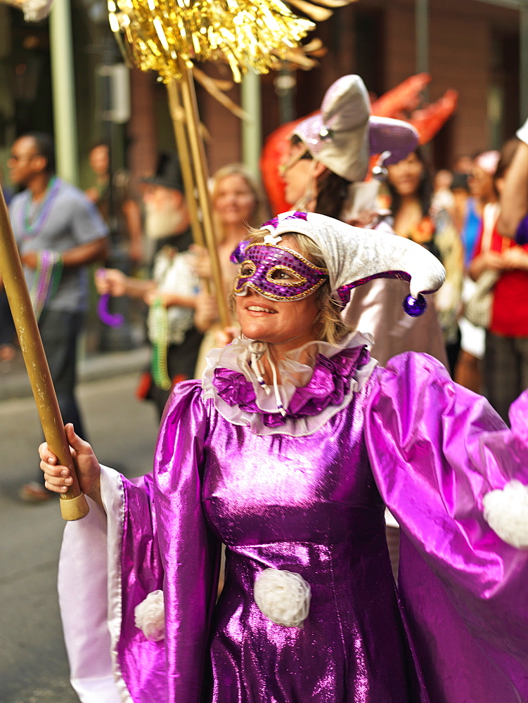 Second line parade with woman in mask, French Quarter, New Orleans, Louisiana, United States of America, North America