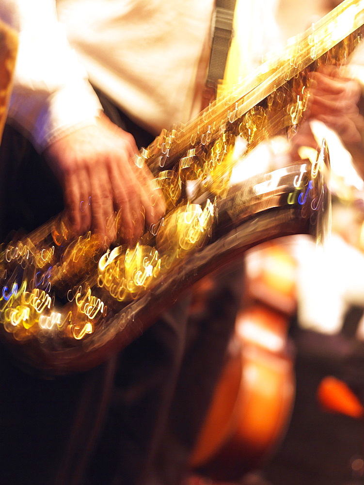 Close-up blur of a saxaphone player in a jazz band, French Quarter, New Orleans, Louisiana, United States of America, North America