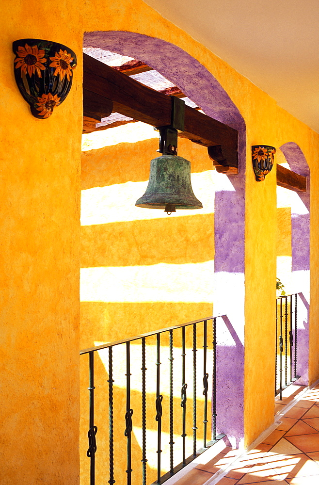 Colorful corridor in hotel with antique brass bell, Playa del Carmen, Yucatan, Mexico, North America