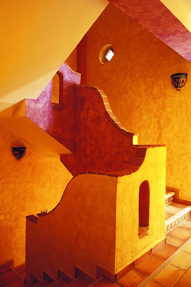 Stairwell in hotel painted in warm colors, Playa del Carmen, Quintana Roo, Mexico, North America