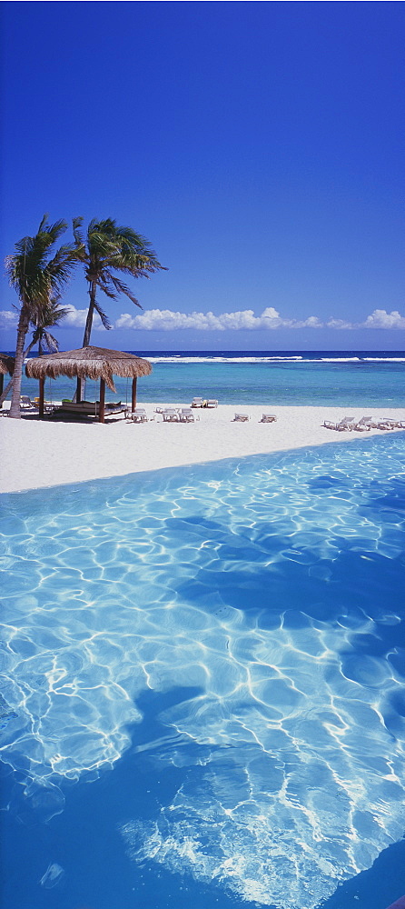 Panorama view of palapa on beach with pool in foreground, Mayan Riviera, Akumal, Yucatan, Quintana Roo, Mexico, North America