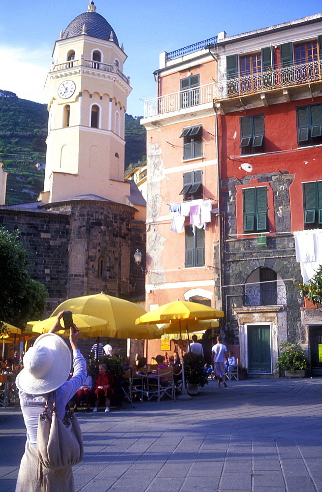 Woman tourist taking photo in the Piazza Gugliemo Marconi, Vernazza, Cinque Terre, UNESCO World Heritage Site, Liguria, Italy, Europe