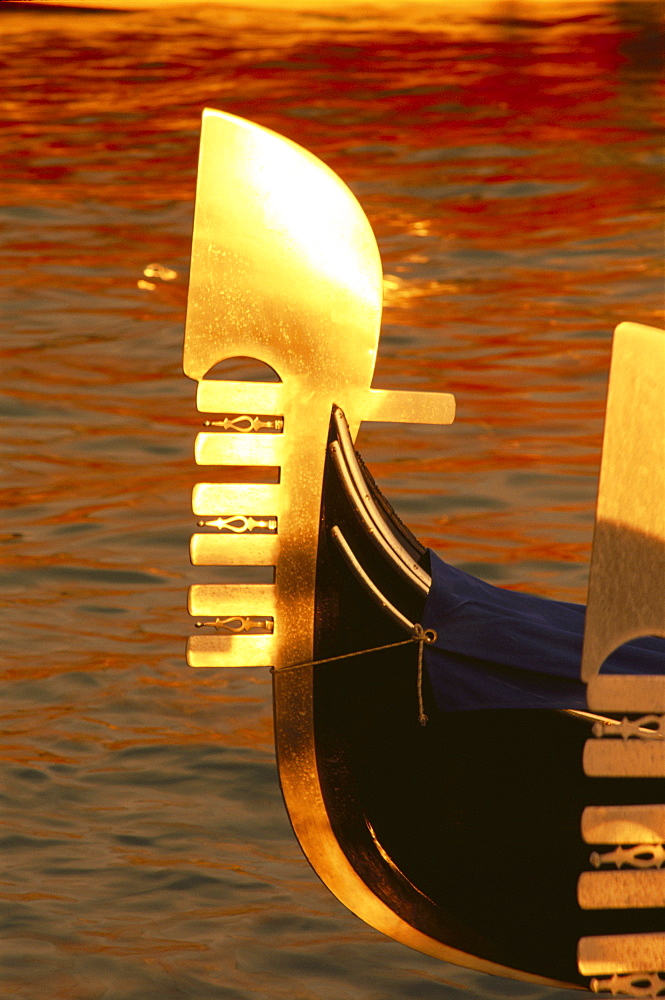 Bow of gondola illuminated at sunset, Venice, Veneto, Italy, Europe