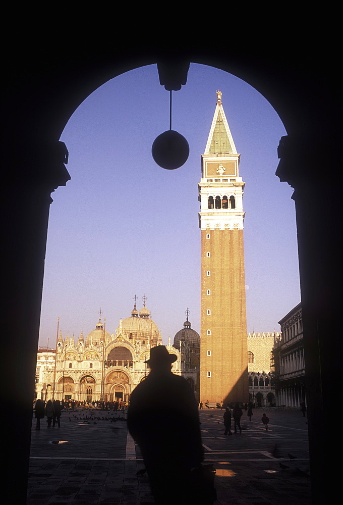 Piazza San Marco viewed through arch with silhouette of a man in foreground, Venice, UNESCO World Heritage Site, Veneto, Italy, Europe