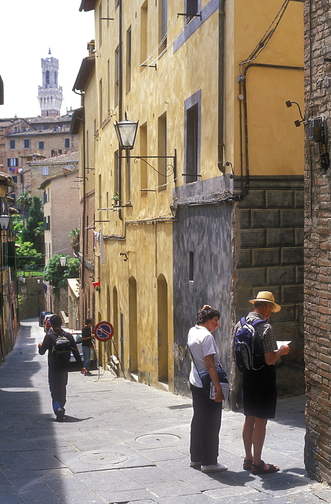 Tourists lost in backstreets, Siena, Tuscany, Italy, Europe