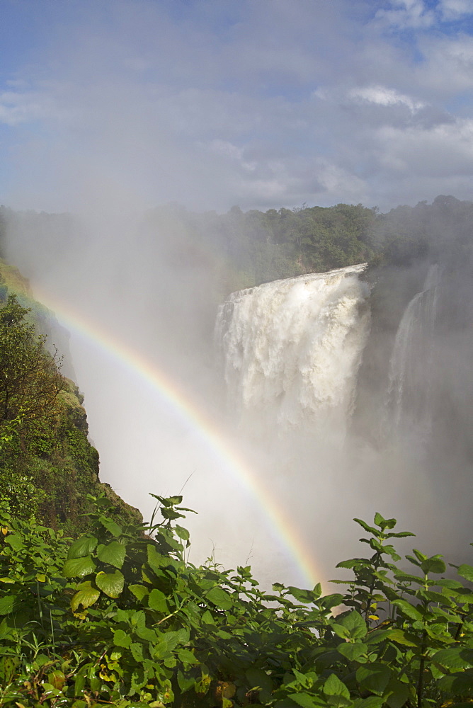 A rainbow in spray by the Victoria Falls waterfall (Mosi-oa-Tunya), UNESCO World Heritage Site, on the border of Zimbabwe and Zambia, Africa