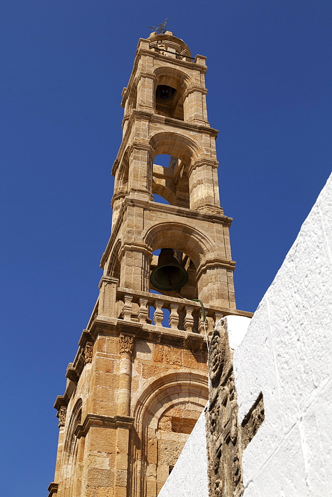 Stone bell tower of the Church of the Panagia, a Greek Orthodox place of worship on Lindos on Rhodes, Dodecanese, Greek Islands, Greece, Europe