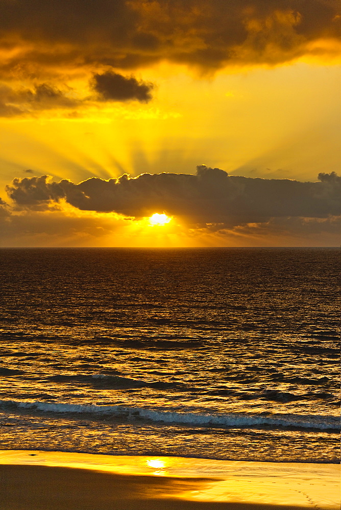 Sunset lighting the clouds offshore from this village on the north west coast, El Cotillo, Fuerteventura, Canary Islands, Spain, Atlantic, Europe