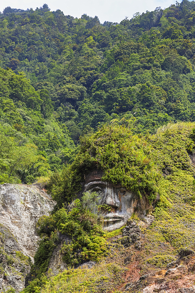 Large carved face at Bukit Kasih, a volcanic tourist park with fumarole fields, a world peace themed tower and worship houses of five major religions, Bukit Kasih, Minahasa, North Sulawesi, Indonesia, Southeast Asia, Asia