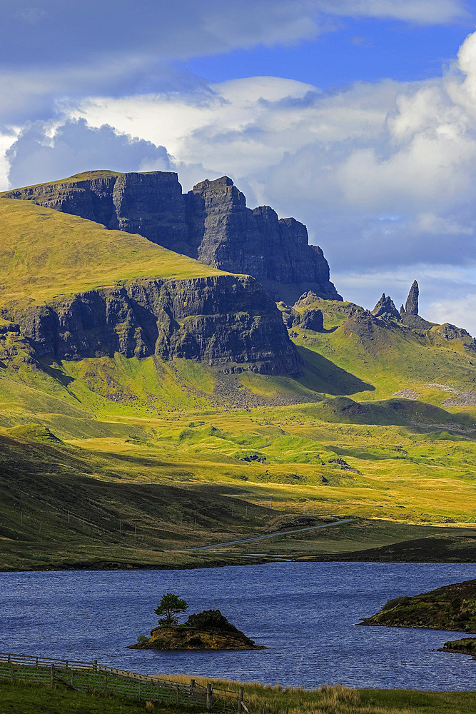 View North from Loch Fada to the towering cliffs of basalt lava over Jurassic sediments at the Trotternish Ridge and the Old Man of Storr, Skye's famed rock spire, Loch Fada, Trotternish Peninsula, Skye, Inner Hebrides, Scotland, United Kingdom, Europe