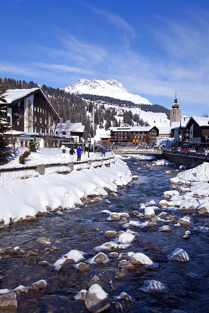 River and village church Lech, near St. Anton am Arlberg in winter snow, Austrian Alps, Austria, Europe