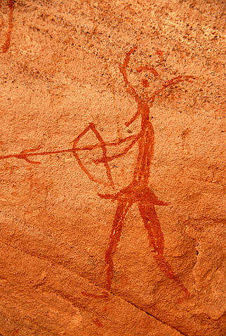 Neolithic rock drawing of a human with bow and arrow and an animals head Acacus Libya