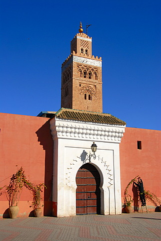 Old minaret and entrance gate Koutoubia mosque Marrakech Morocco