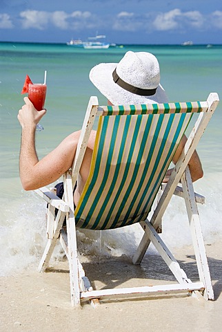 Man with cocktail at seashore