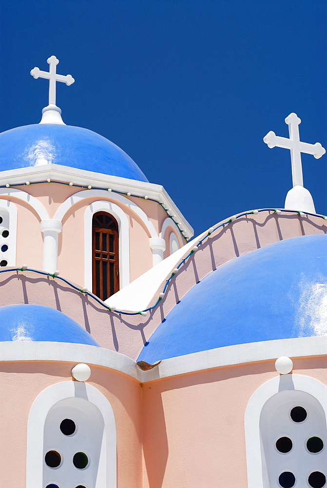 Light pink church, chapel with blue domes in Mykonos City, Cyclades, Greece, Europe