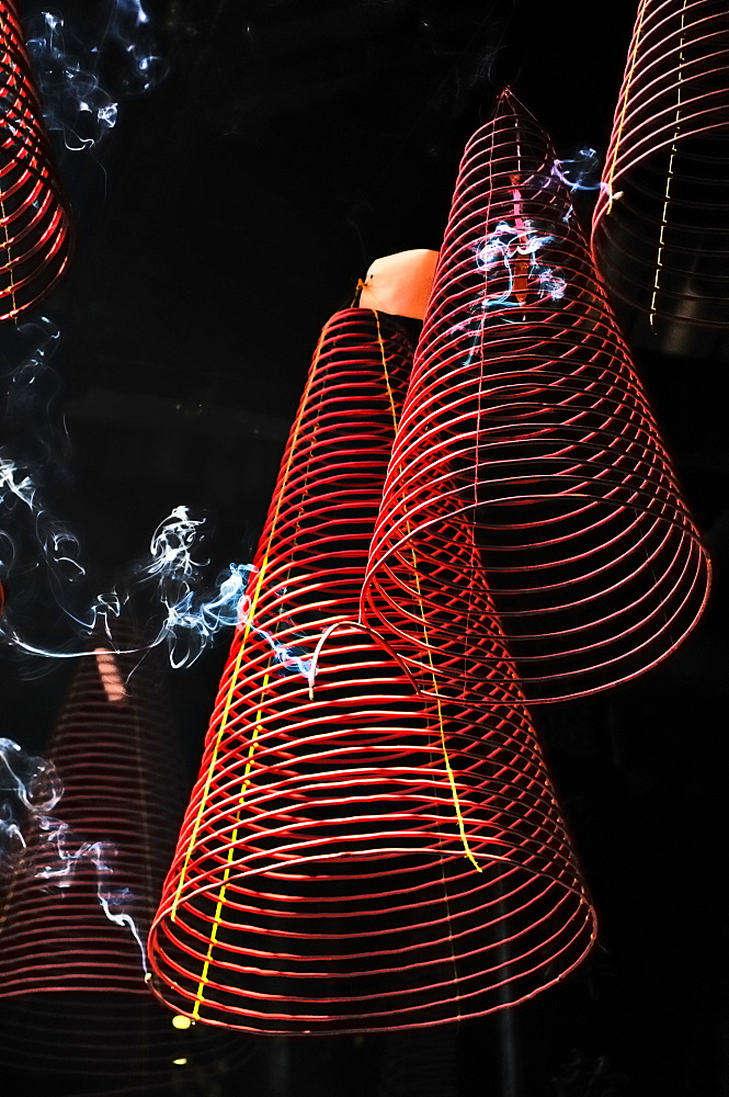 Ascending smoke, red incense steeming spirals in Phuoc An Hoi Quan Pagoda, Ho Chi Minh City, Saigon, Vietnam, Southeast Asia