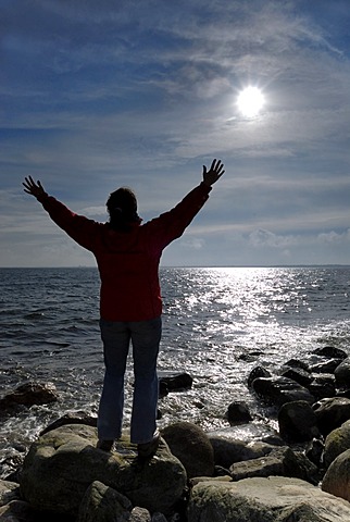 Woman spreads her arms and enjoys the sun, Kiel Bay, Schleswig-Holstein, Germany