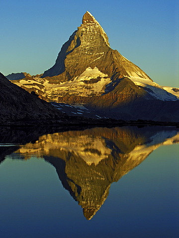 The Matterhorn is reflected in the Riffelsee near Zermatt, canton Wallis, Switzerland