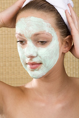 Young woman with a facial mask