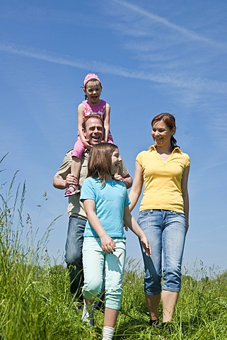 Family walking relaxed in a flower meadow