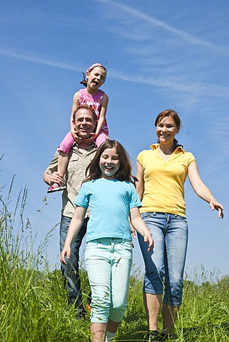 Family walking relaxed in a flower meadow