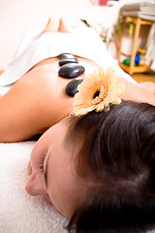 Patient in a physiotherapy practice getting a Hot Stone Massage