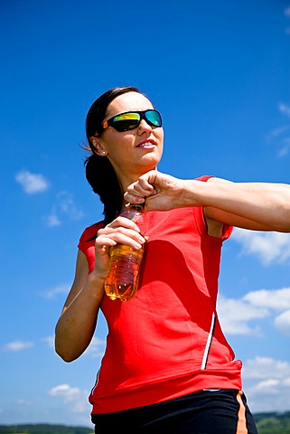 Young woman drinking after a run