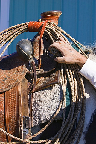 Horse saddle and cowboy hand, wildwest, Oregon, USA