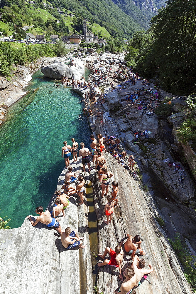 Bathing people on rocks at Verzasca, near Lavertezzo, Verzascatal, Valle Verzasca, Canton Ticino, Switzerland, Europe