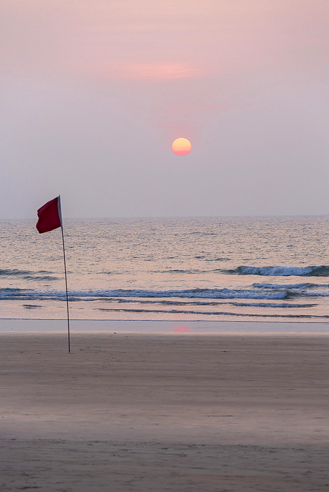 Lifeguard flag in sunset at Agonda Beach, Goa, India, Asia