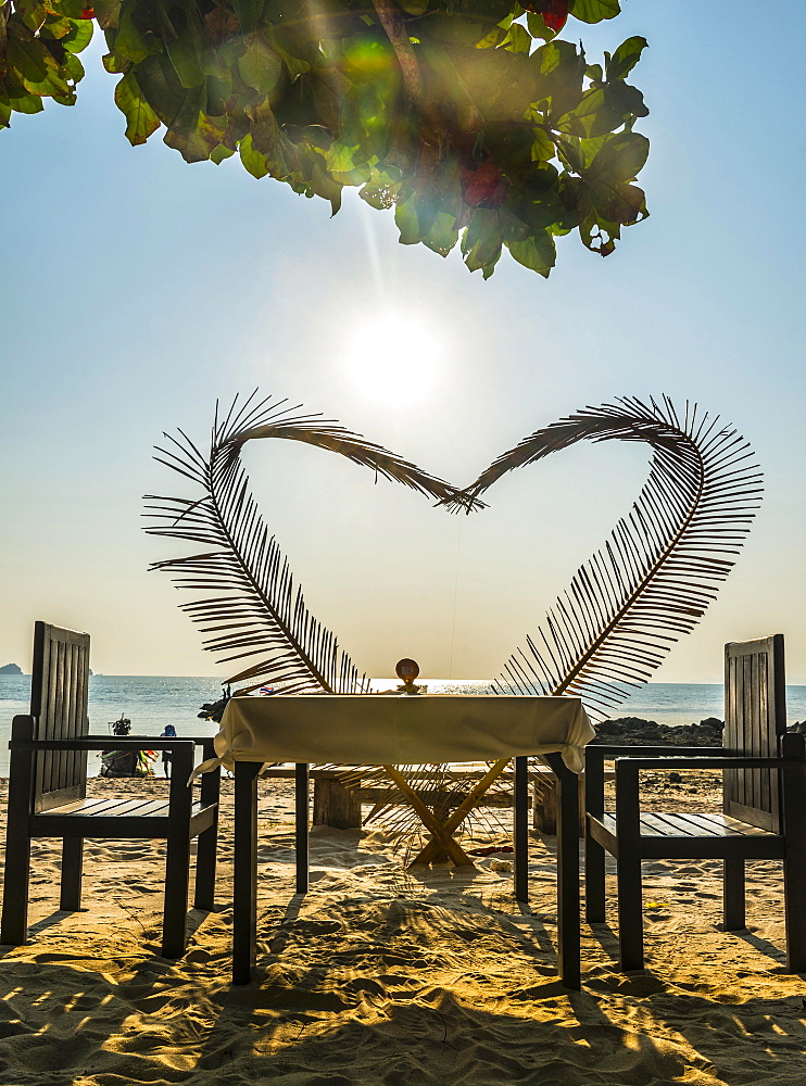 Laid table with a heart of palm fronds, sunset, Koh Samui, Gulf of Thailand, Thailand, Asia