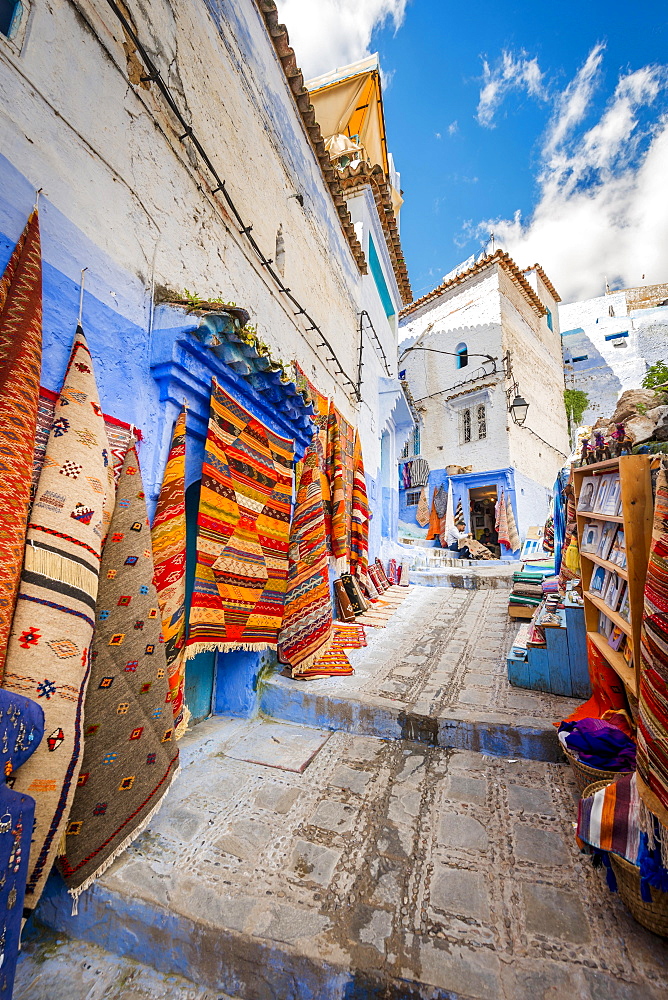 Narrow alley, carpet and craft shop, blue houses, medina of Chefchaouen, Chaouen, Tangier-Tétouan, Morocco, Africa