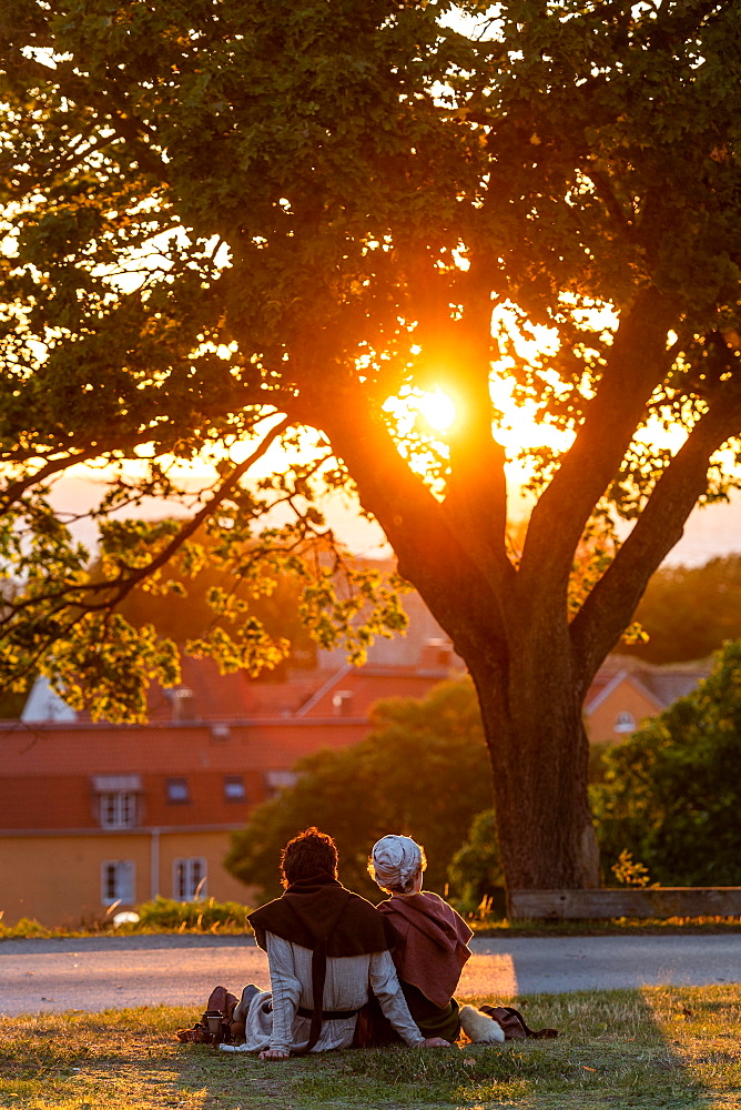 Visitors of the Medieval Week watch sunset over the Old Town, Visby, Gotland Island, Sweden, Europe