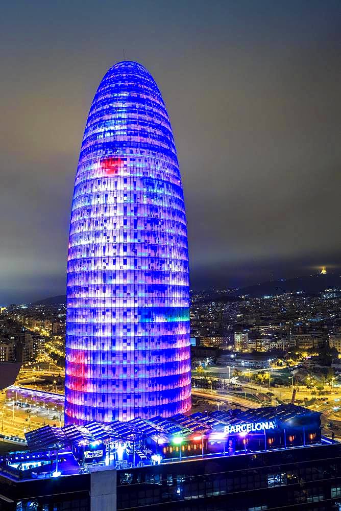 Blue illuminated Agbar Tower and city at Night, Barcelona, Catalonia, Spain, Europe