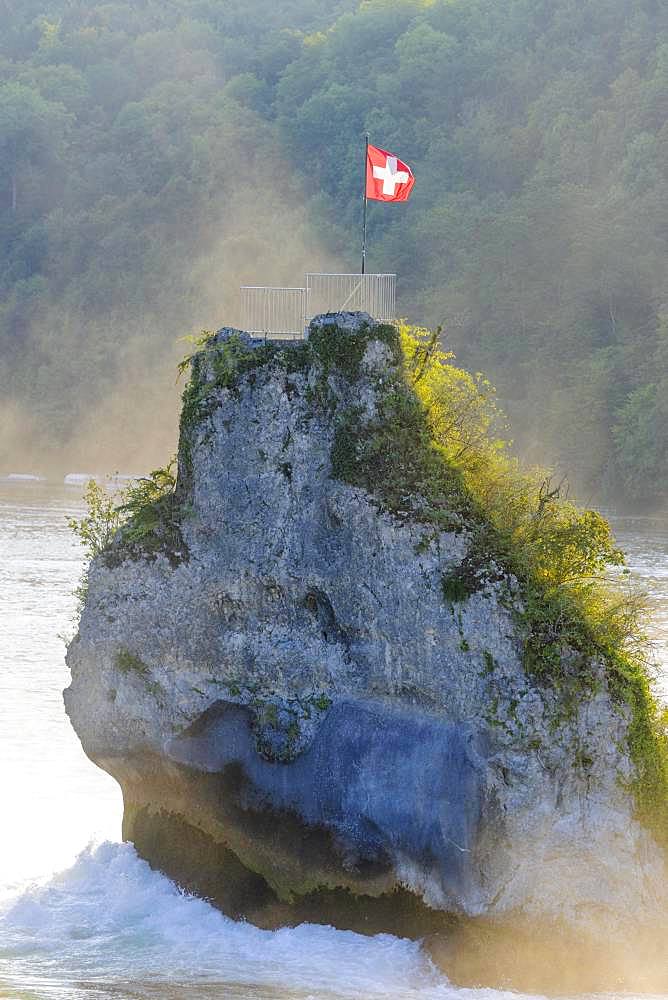 Vantage point, rock at the Rhine Falls with Swiss flag, Schaffhausen, Switzerland, Europe