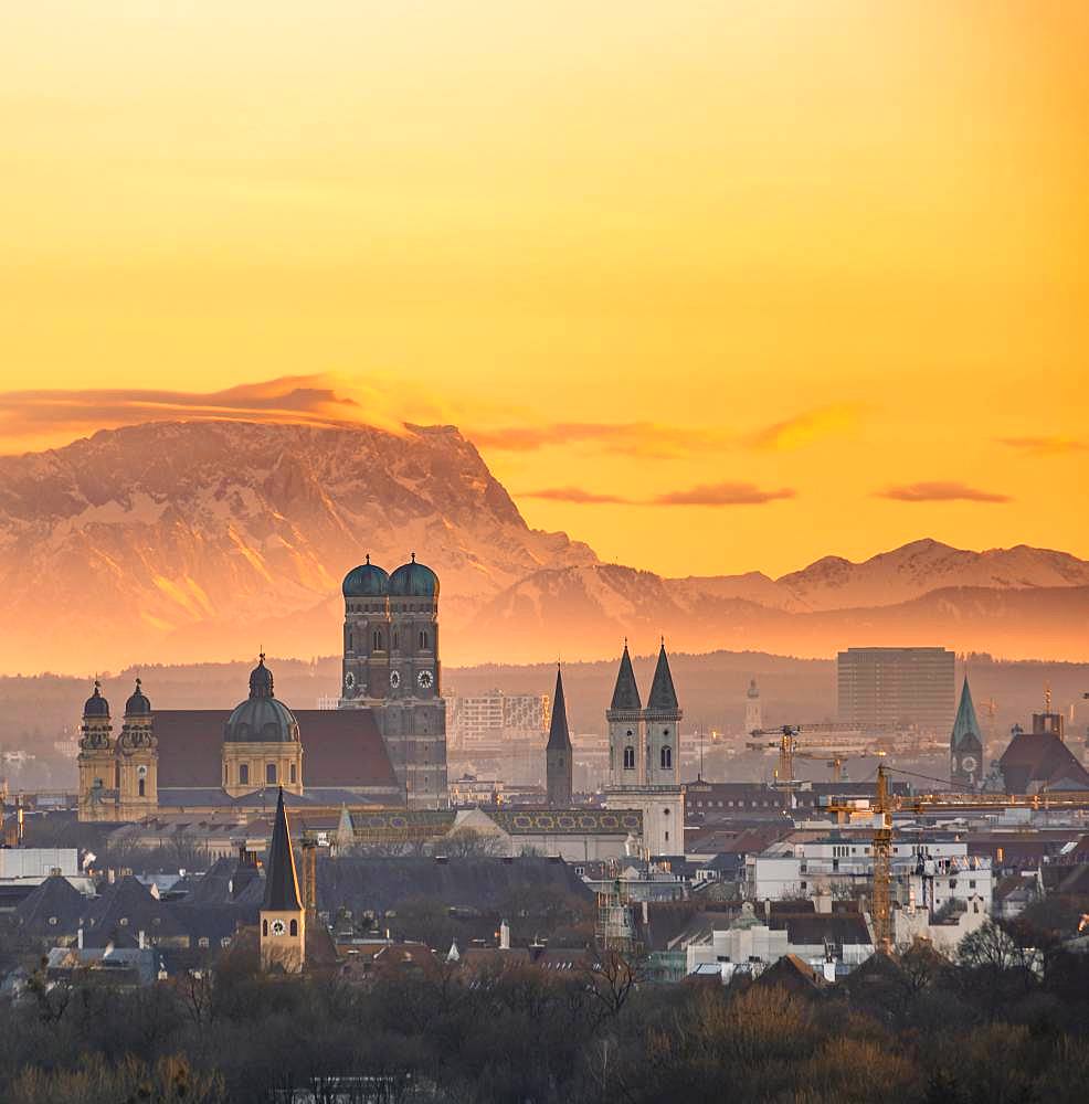 View over Munich with Church of Our Lady, Theatine Church, Ludwigskirche, behind Zugspitze at sunset, Munich, Bavaria, Germany, Europe