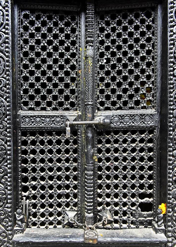 Artfully carved window grilles in traditional Newar style in Kumari Chowk inner courtyard, Kumari Bahal Temple, Durbar Square, Kathmandu, Nepal, Asia