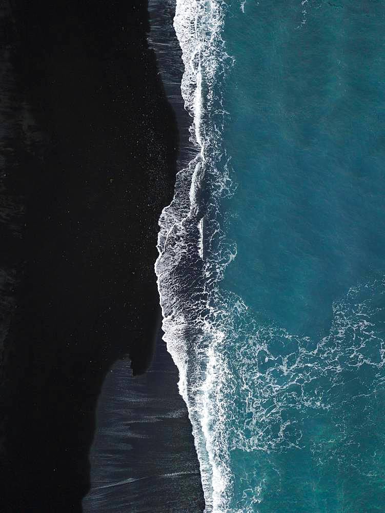 Black volcanic beach with waves running out from above, black sand, drone shot, Lanzarote, Spain, Europe